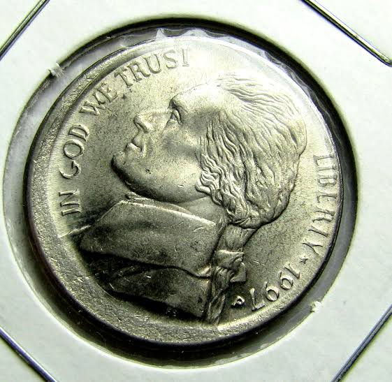 1997 Jefferson nickel off-center strike error showing design misaligned with blank planchet crescent visible at coin edge