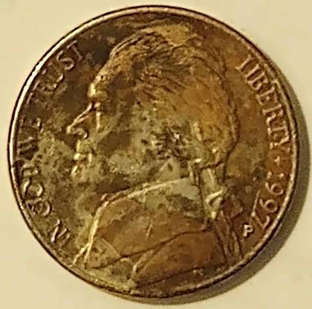 Wrong planchet error showing 1997 Jefferson nickel design struck on a Lincoln cent planchet, displaying different size and copper color